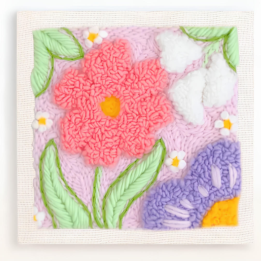 Floral design with pink flower, green leaves, and purple flower on a textured surface.
