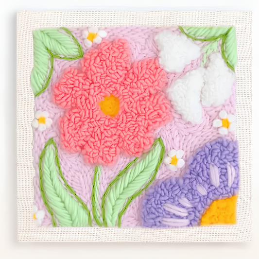Floral design with pink flower, green leaves, and purple flower on a textured surface.