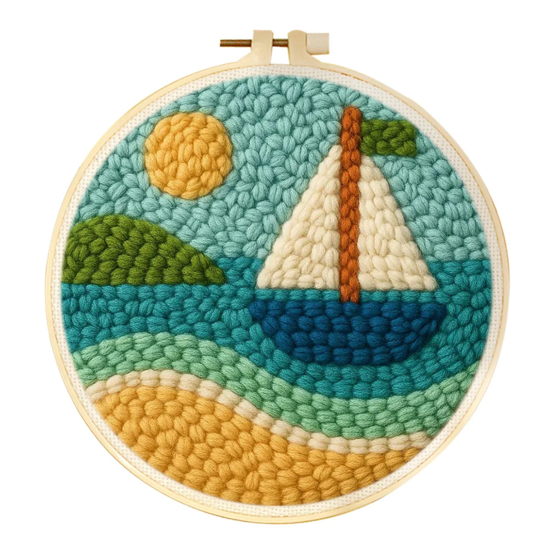 Embroidery hoop with a yarn art design of a sailboat, sun, and landscape.