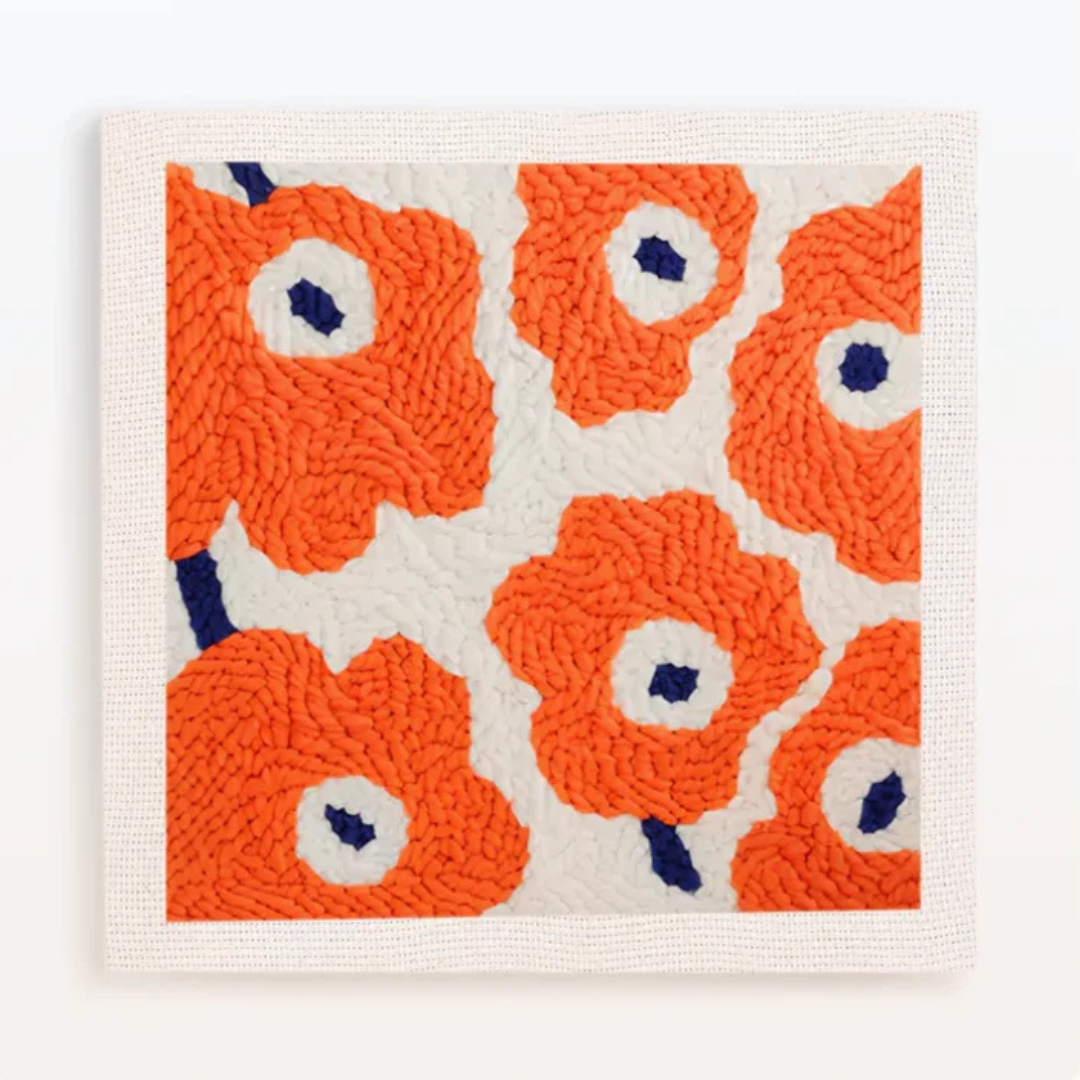 Decorative rug with orange floral pattern on a white background