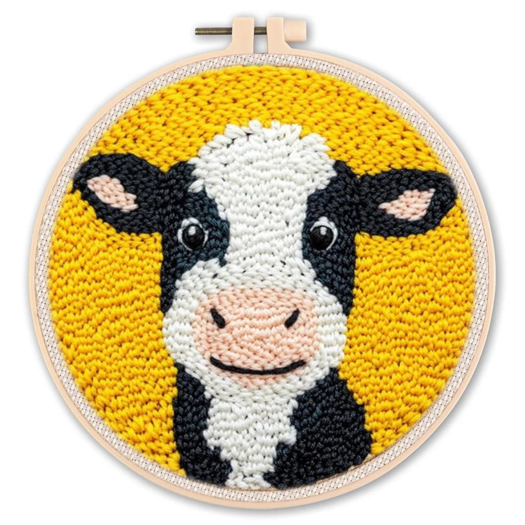 Embroidery hoop with a cow design on a yellow background
