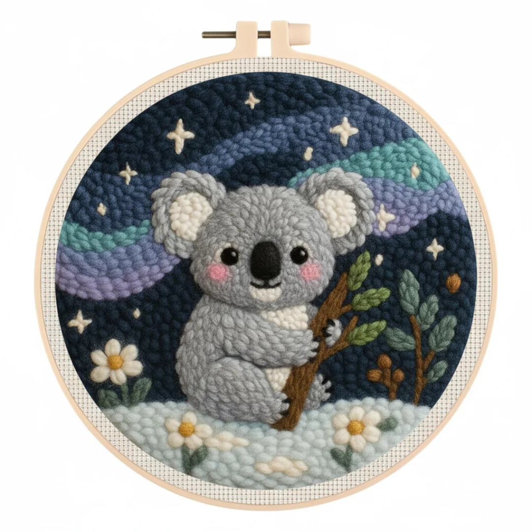 Embroidery hoop with a koala design against a starry night sky.