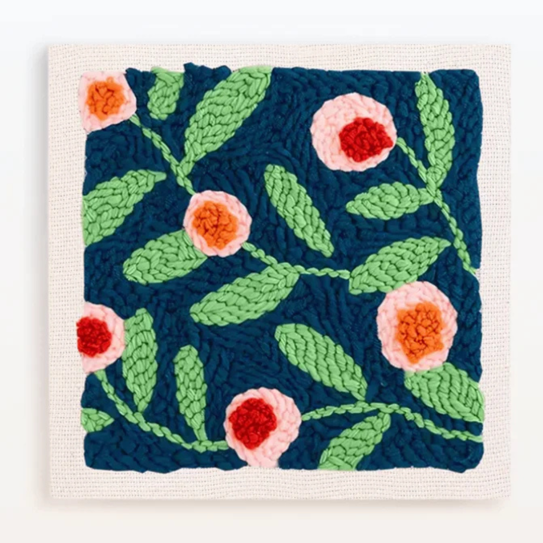 Crocheted square with floral pattern on a white background
