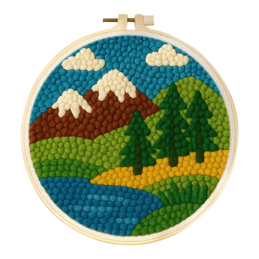 Embroidery hoop with a mountain landscape design on a white background