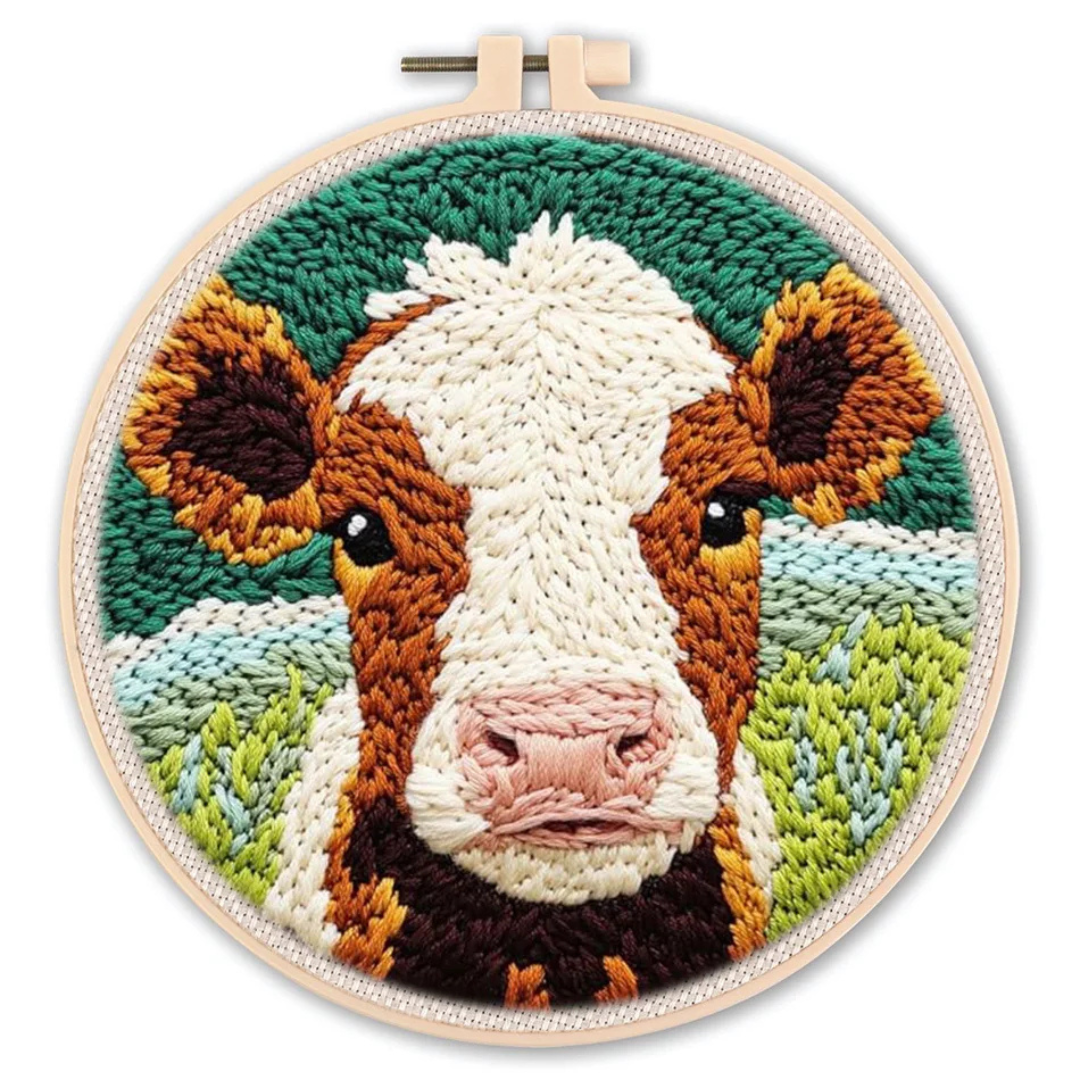 Embroidery of a cow's face in an embroidery hoop on a white background
