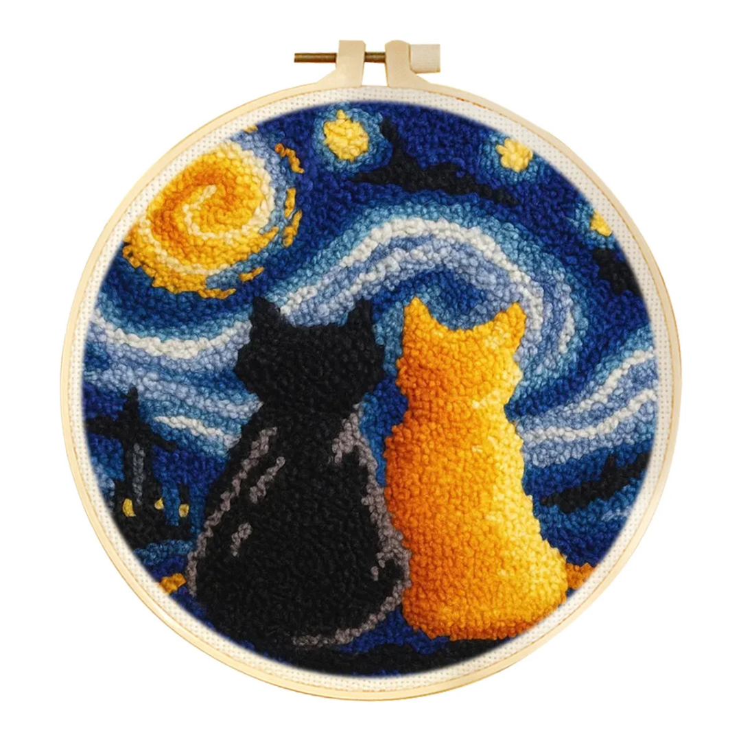Embroidery hoop with cats and a starry night design
