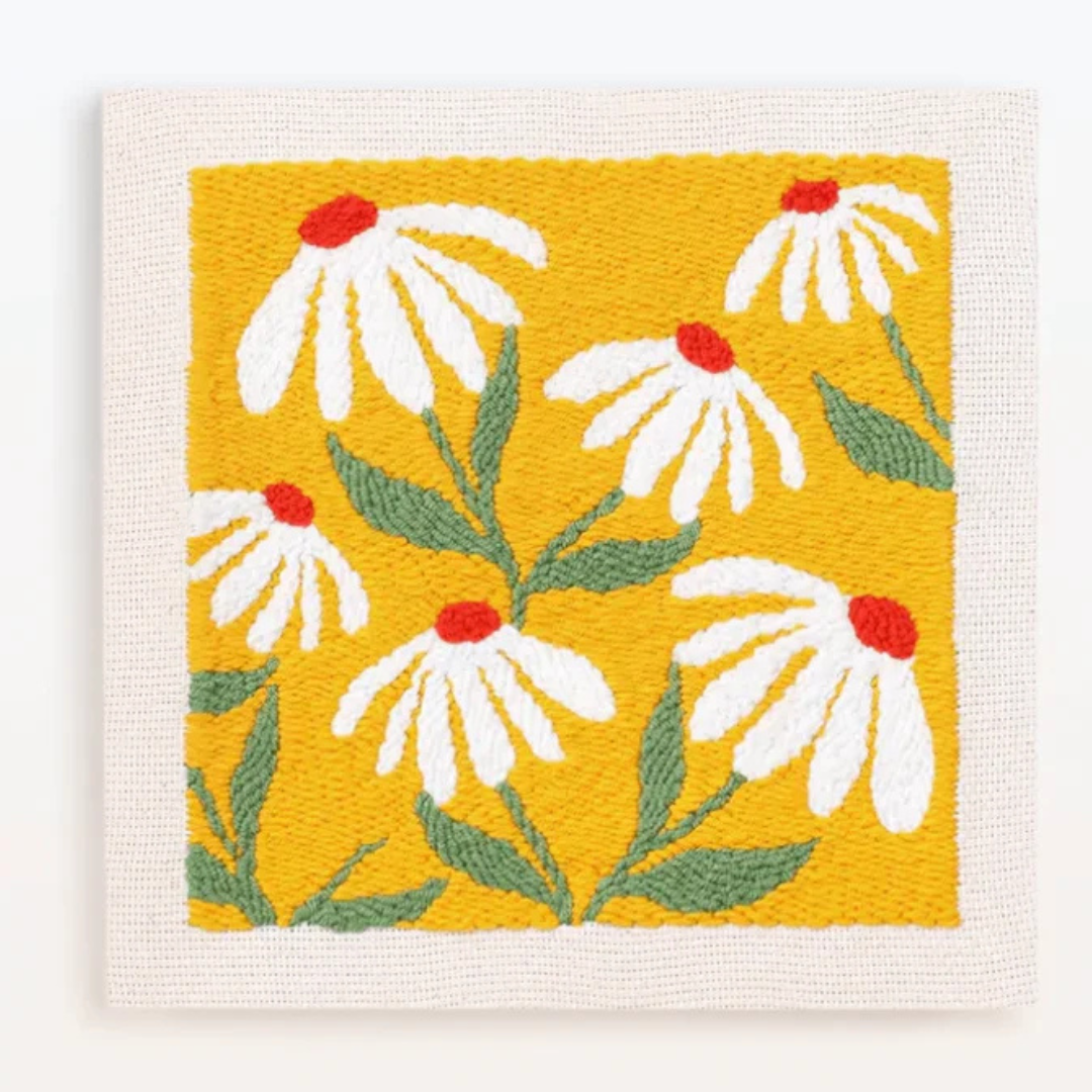 Woven fabric with white flowers and red centers on a yellow background