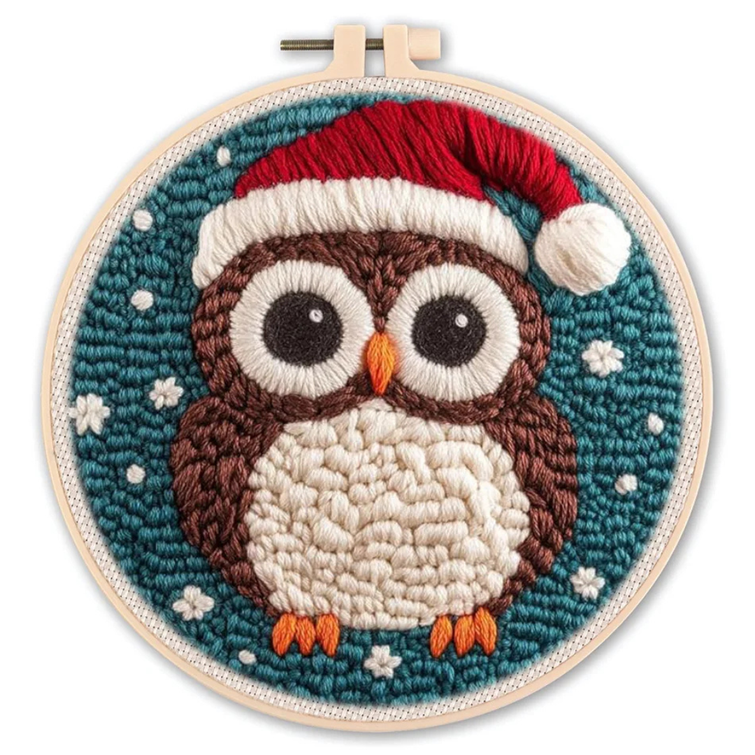 Embroidery hoop with a Christmas-themed owl design on a blue background.